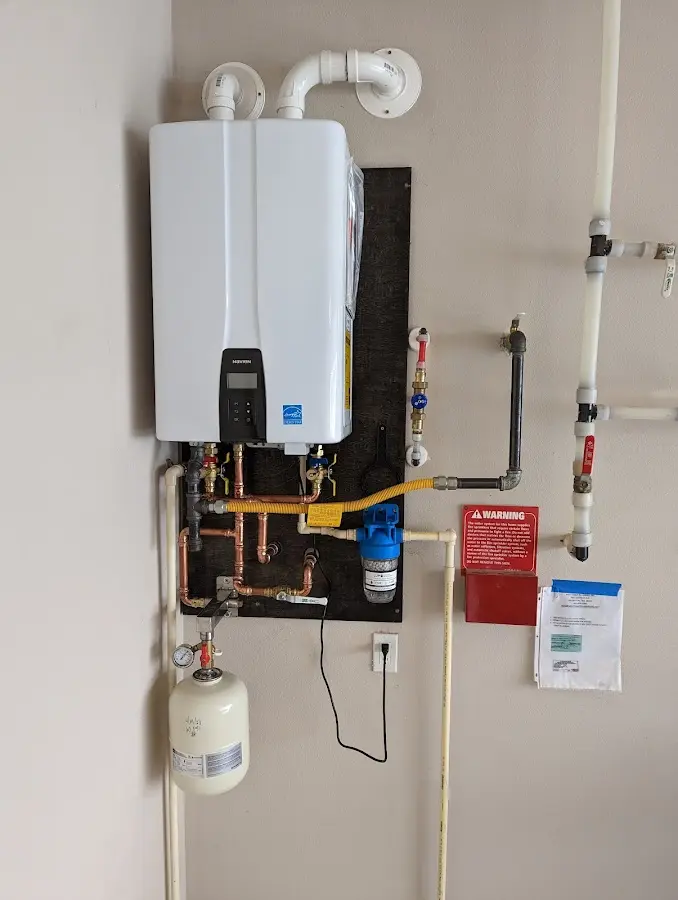 Professional plumber installing copper piping in a Royersford home